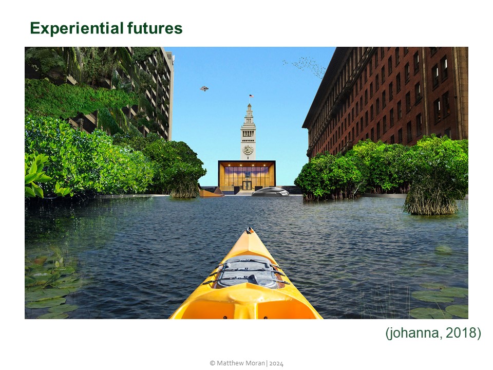 View through the window of the Sea Level Stories apartment showing a flooded street between two multistory urban buildings. Vegetation has become established in the flooded streets. We appear to be sitting and travelling in in a bright yellow canoe, as the prow of the canoe points into the centre of the image.